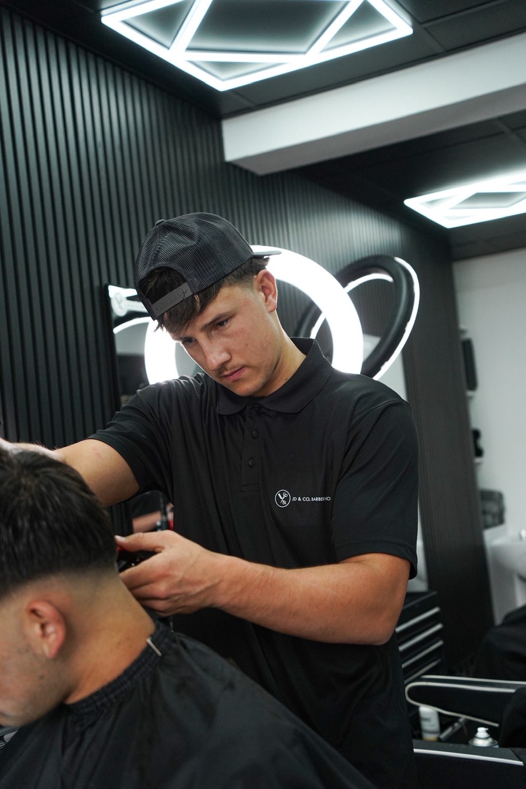 Jacob Hardy cutting hair at JD&Co Barbershop